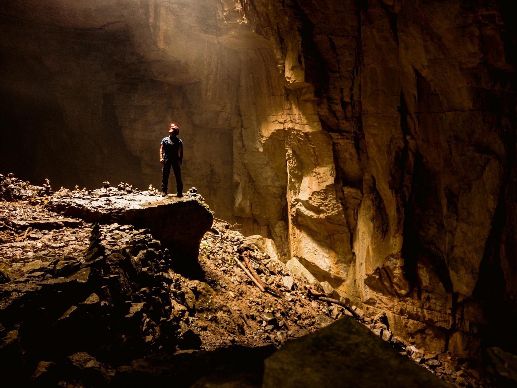 man standing inside a rocky cave
