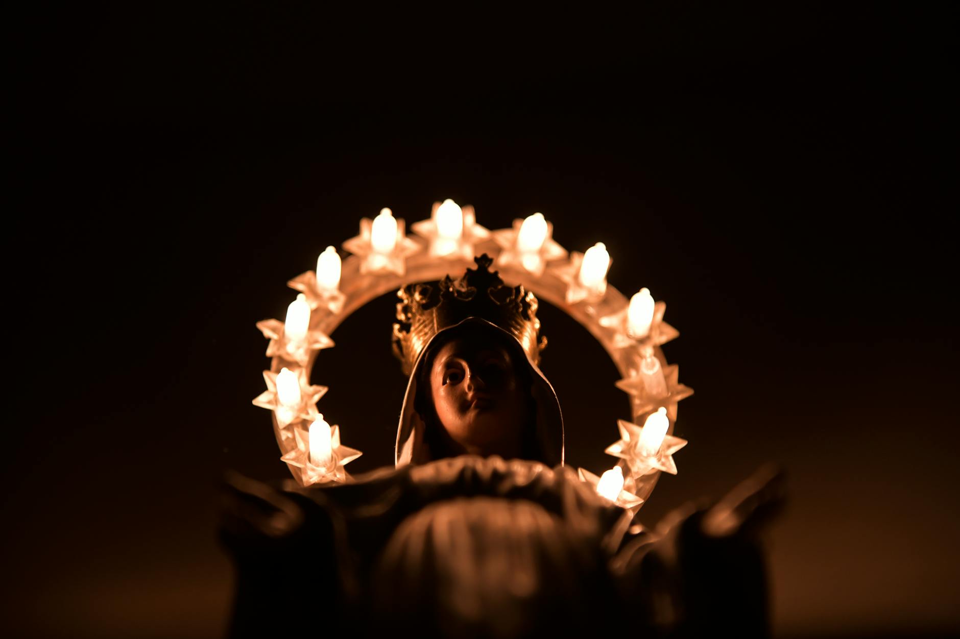 madonna statue holding a lighted crown