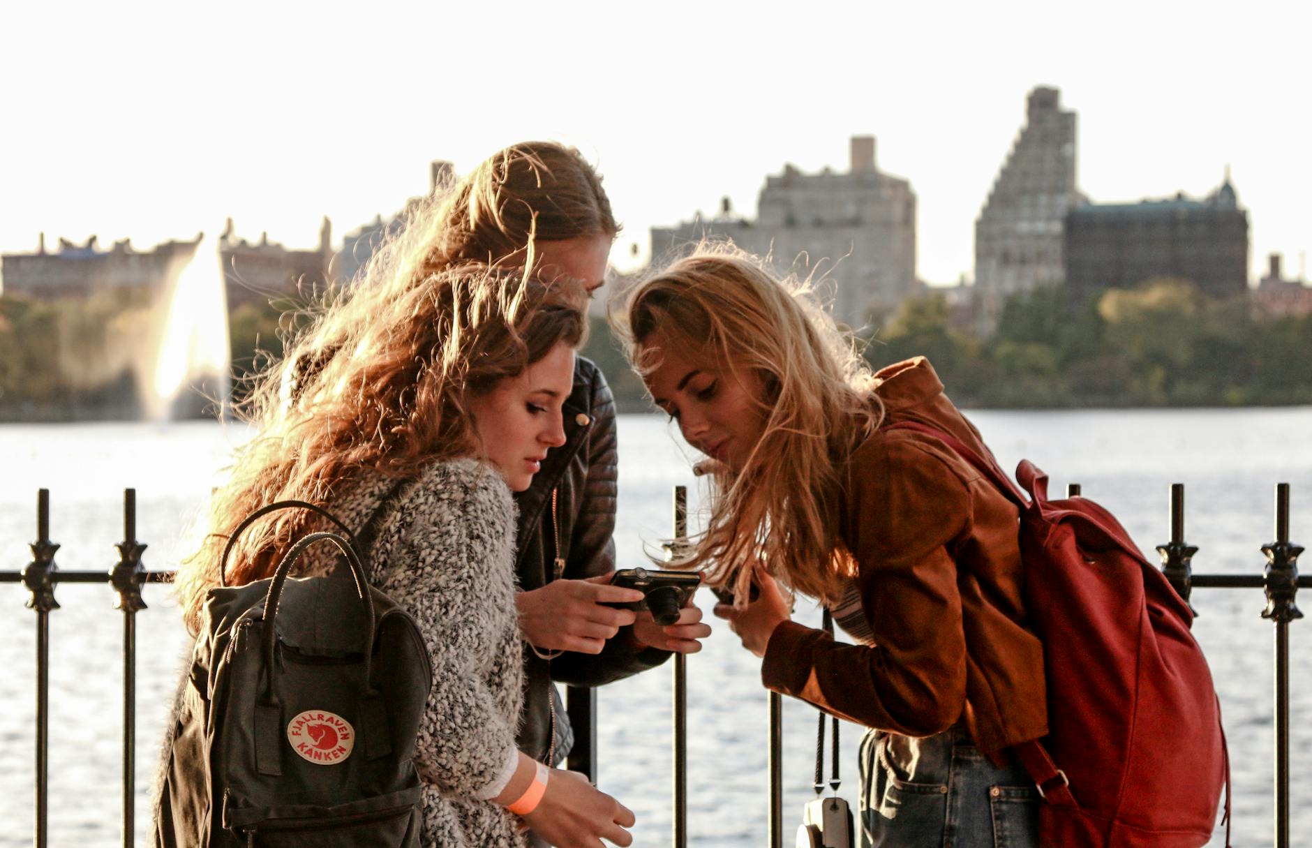 friends looking at a digital camera